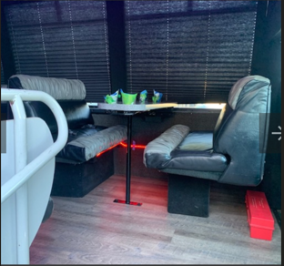 Party bus interior — dinette seating with LED accents