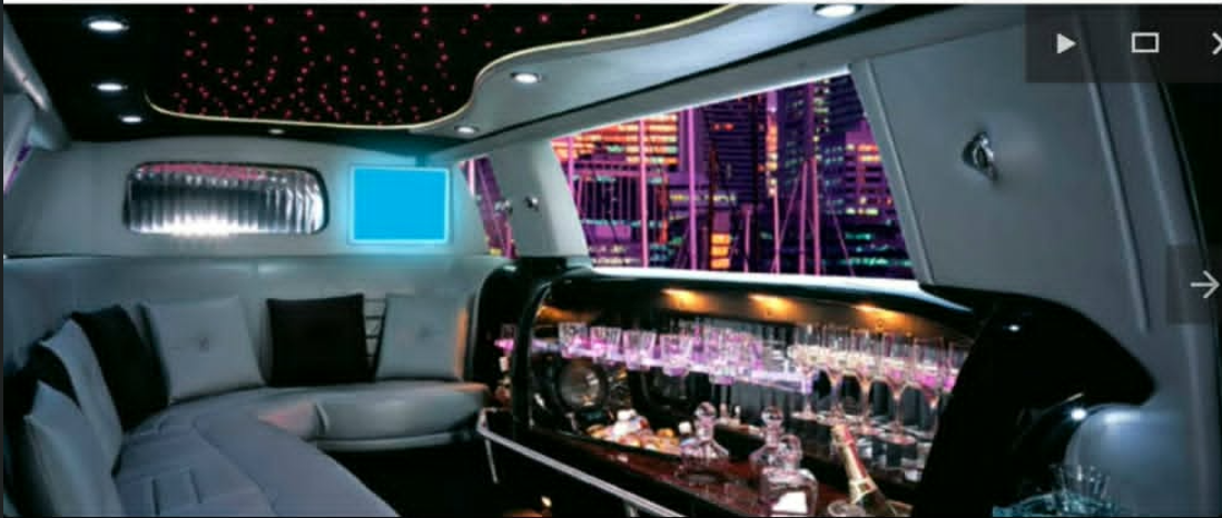 Stretch limousine interior with bar and city skyline view